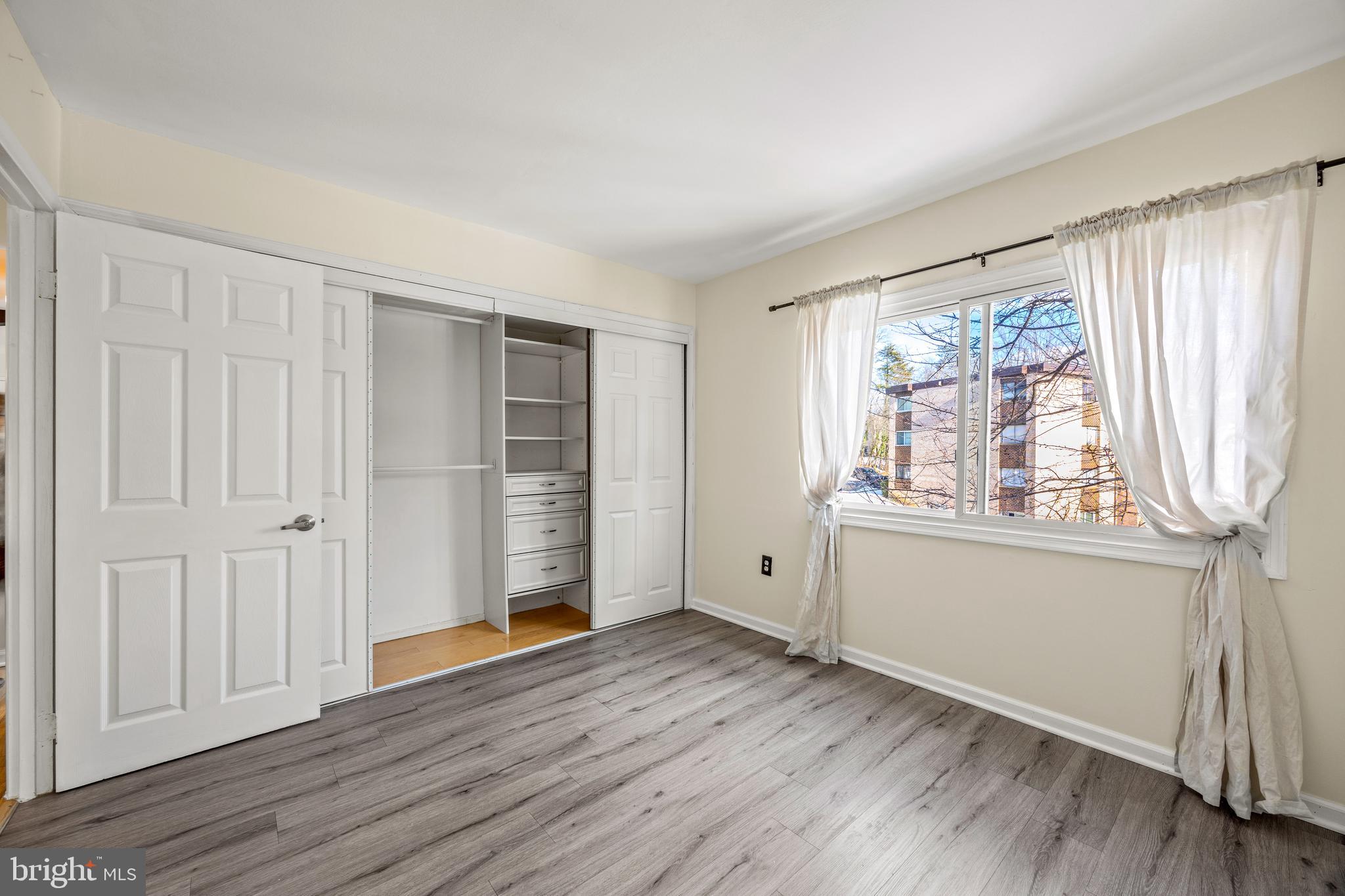 3736 Bel Pre Road, Unit 37367 Silver Spring, MD 20906 - Photo 23 of 27 an empty room with wooden floor and windows