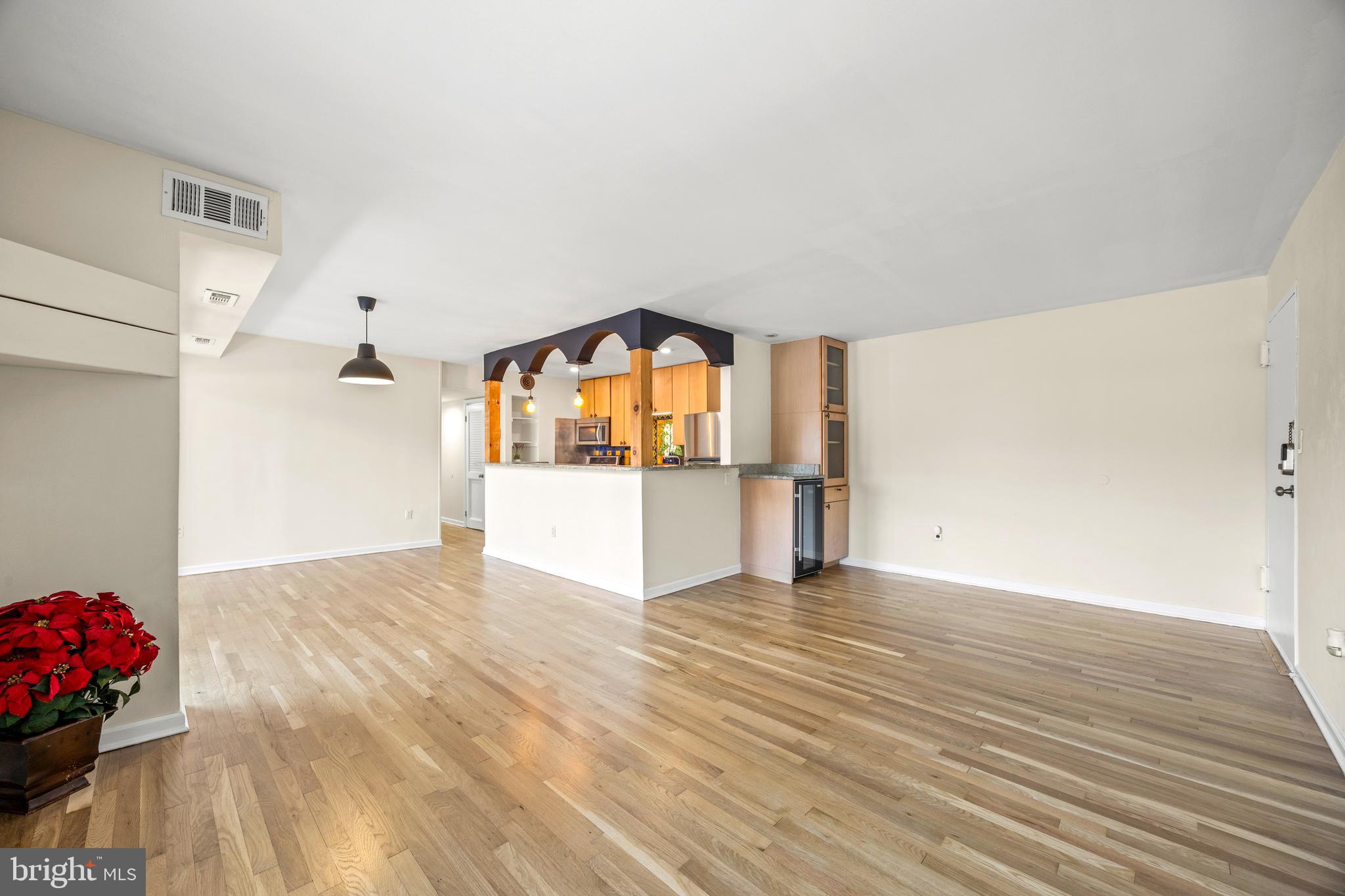 3736 Bel Pre Road, Unit 37367 Silver Spring, MD 20906 - Photo 3 of 27 a view of empty room with wooden floor and kitchen view