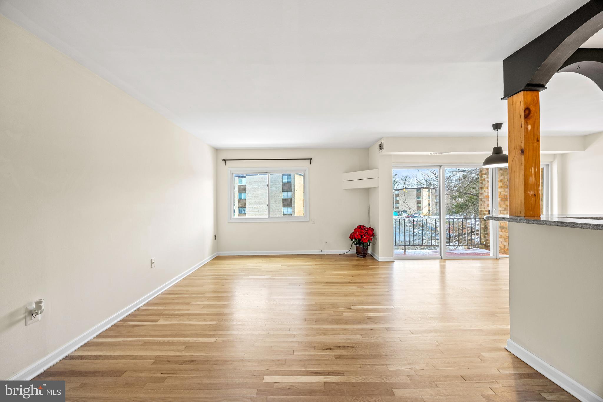 3736 Bel Pre Road, Unit 37367 Silver Spring, MD 20906 - Photo 6 of 27 an empty room with wooden floor and windows