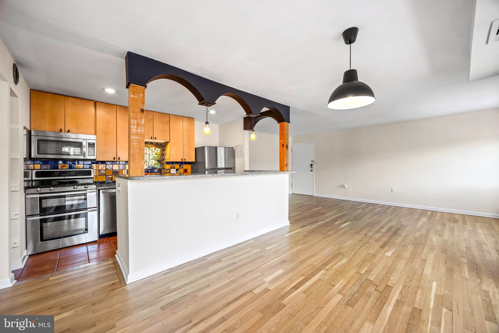 3736 Bel Pre Road, Unit 37367 Silver Spring, MD 20906 - Photo 8 of 27 a kitchen with stainless steel appliances granite countertop a sink a stove and a wooden floors