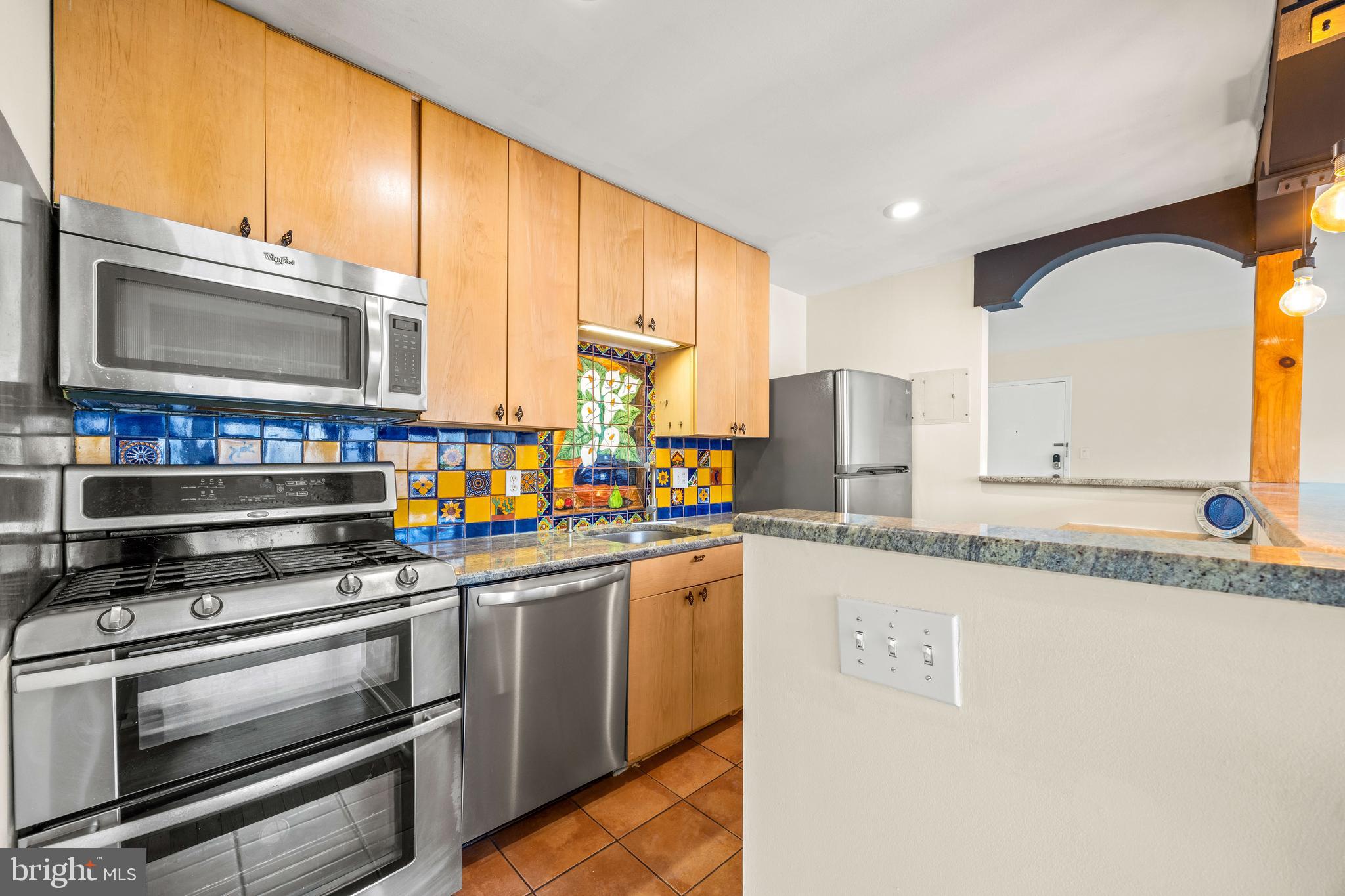 3736 Bel Pre Road, Unit 37367 Silver Spring, MD 20906 - Photo 9 of 27 a kitchen with stainless steel appliances a stove a sink and a microwave
