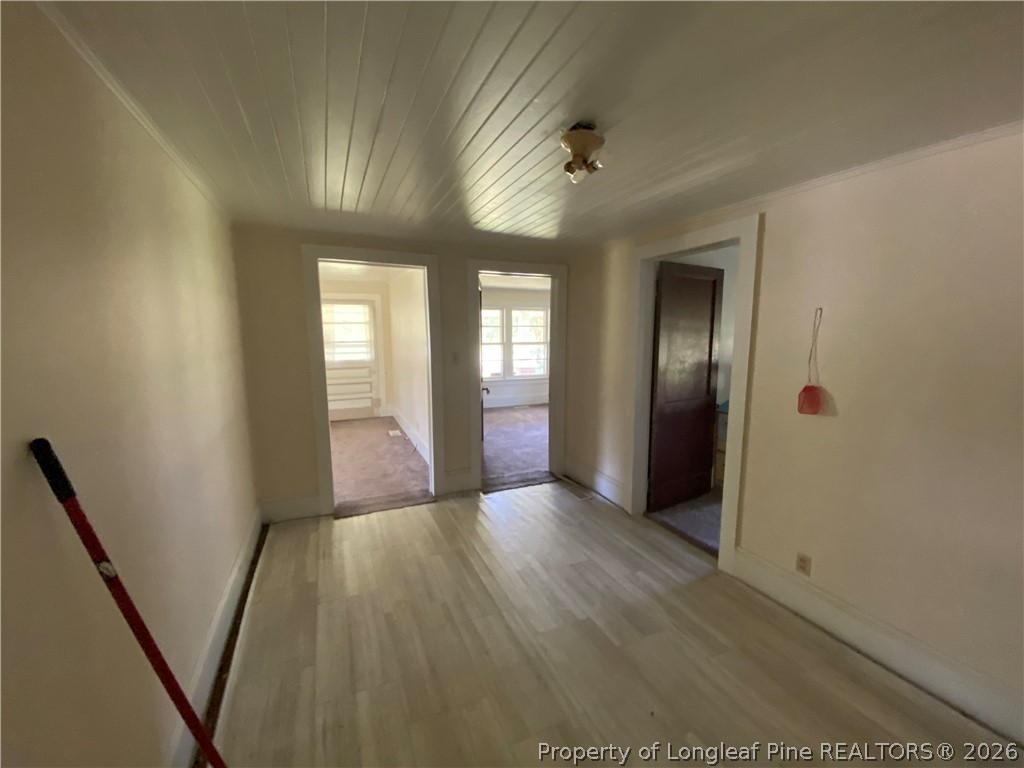 10717 Colliers Chapel Church Road Linden, NC 28356 - Photo 15 of 20 an empty room with wooden floor and windows