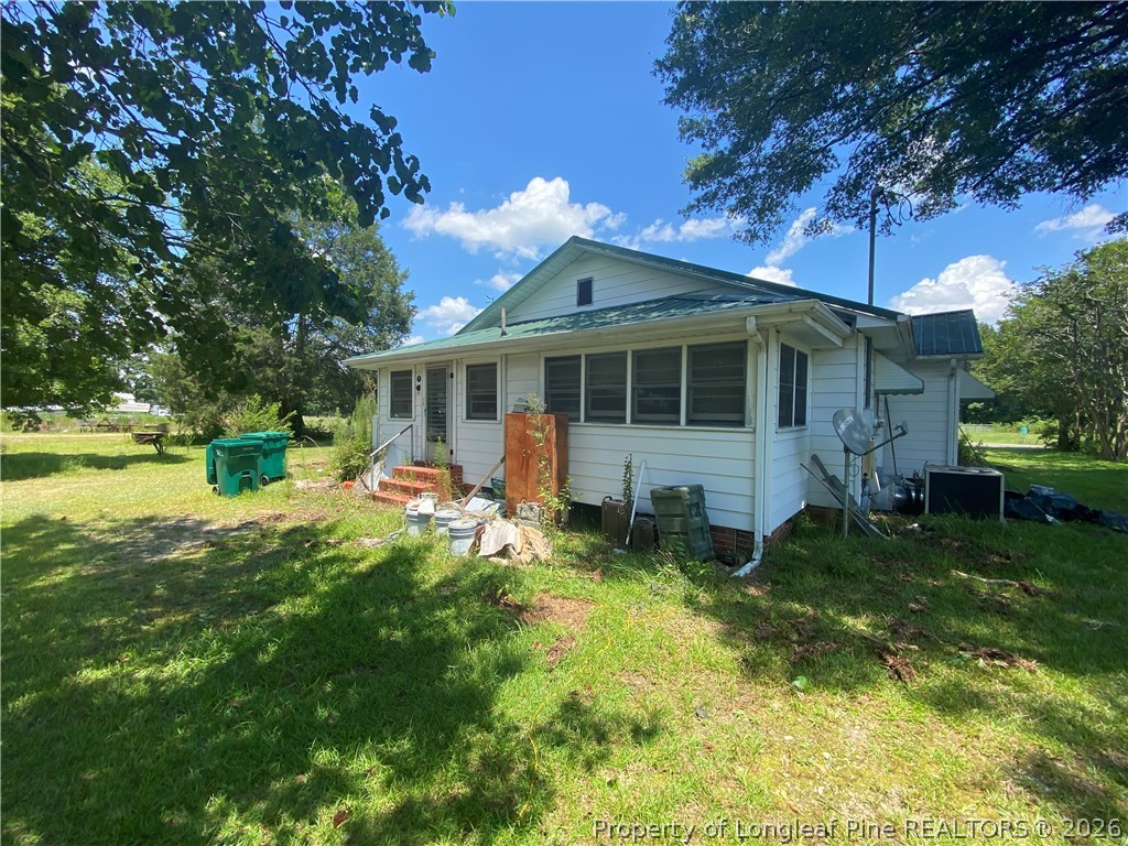 10717 Colliers Chapel Church Road Linden, NC 28356 - Photo 19 of 20 a view of a house with a yard porch and sitting area