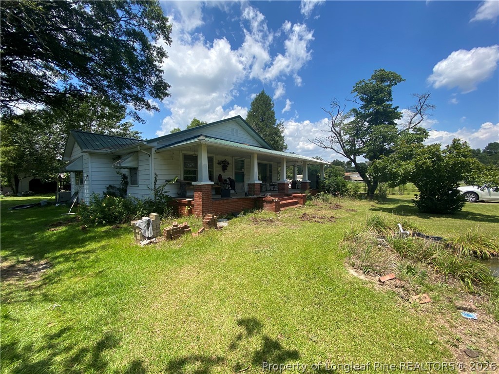 10717 Colliers Chapel Church Road Linden, NC 28356 - Photo 2 of 20 a view of a house with swimming pool and a yard