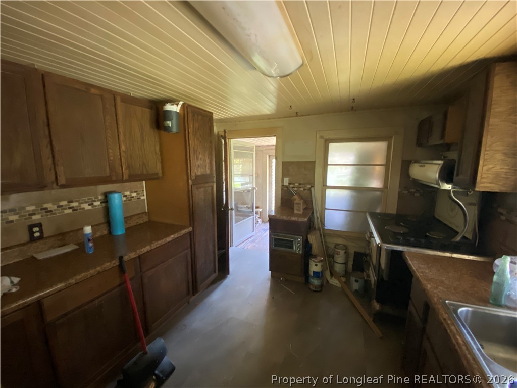 10717 Colliers Chapel Church Road Linden, NC 28356 - Photo 6 of 20 a kitchen with a sink appliances and cabinets