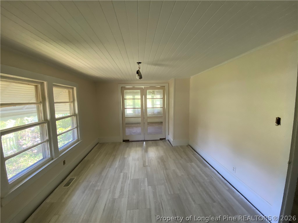 10717 Colliers Chapel Church Road Linden, NC 28356 - Photo 10 of 20 an empty room with wooden floor and windows
