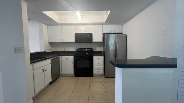 a kitchen with stainless steel appliances a sink stove and refrigerator