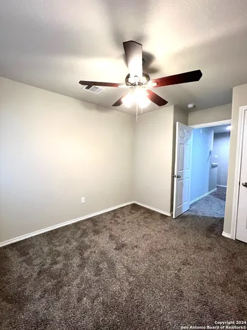 an empty room with a ceiling fan