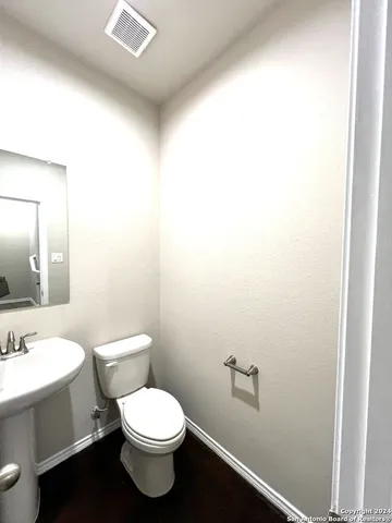 a white toilet sitting next to a bathroom sink