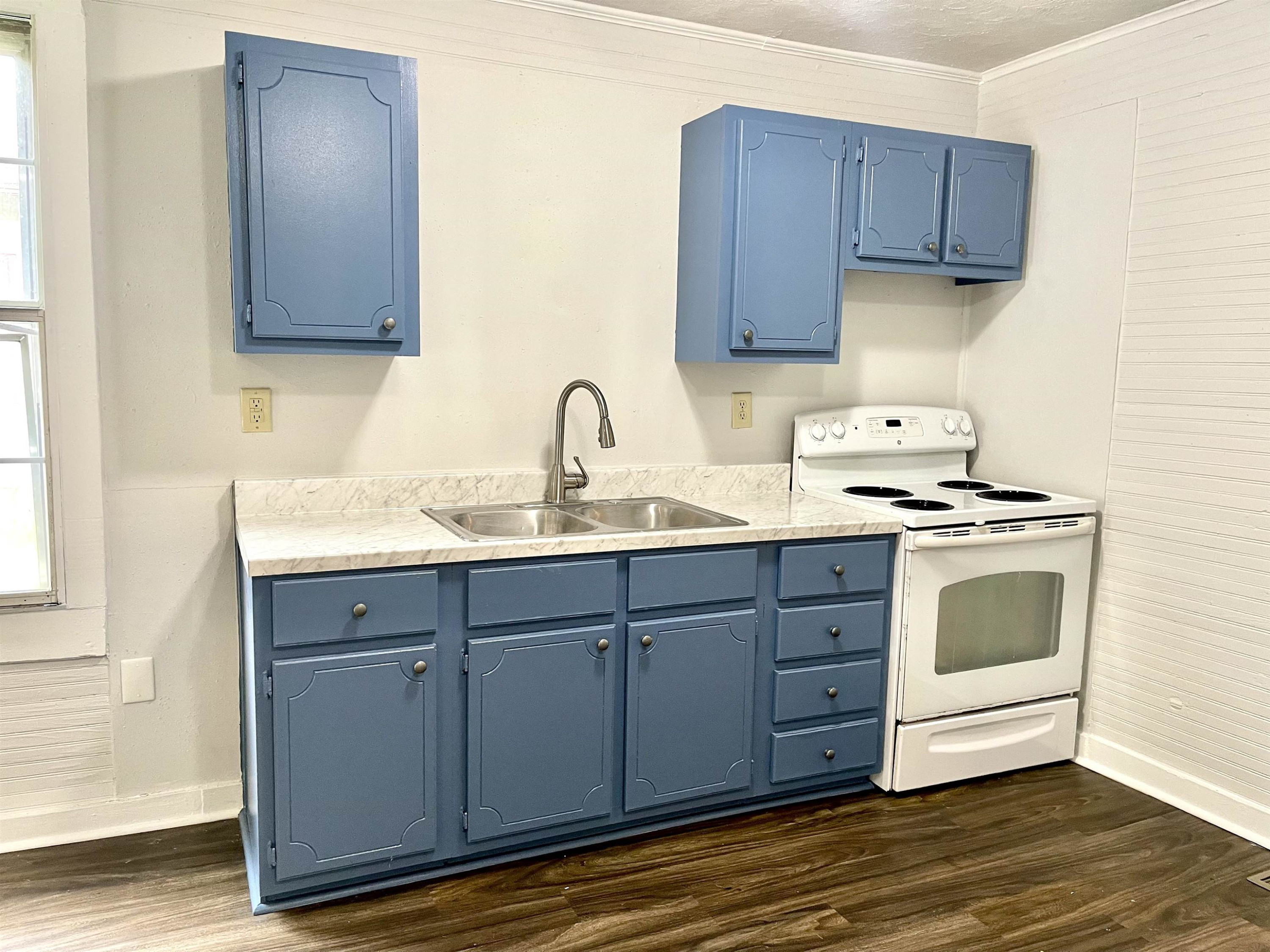 1 Butler Street Jackson, TN 38301 - Photo 10 of 13 a kitchen with stainless steel appliances granite countertop a sink a stove and cabinets