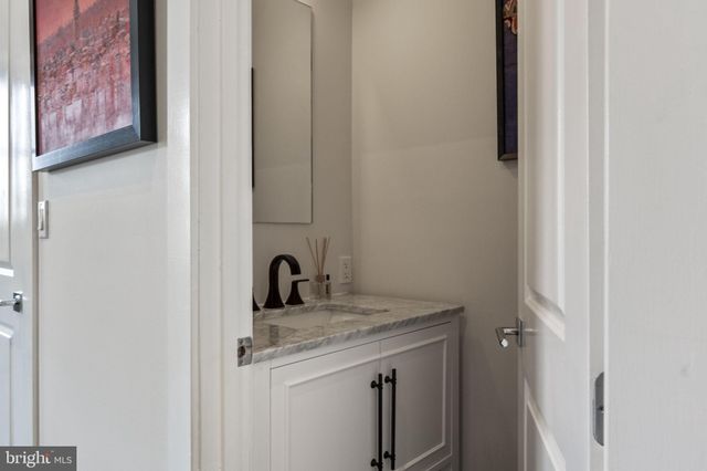 a view of a bathroom with a sink and a mirror