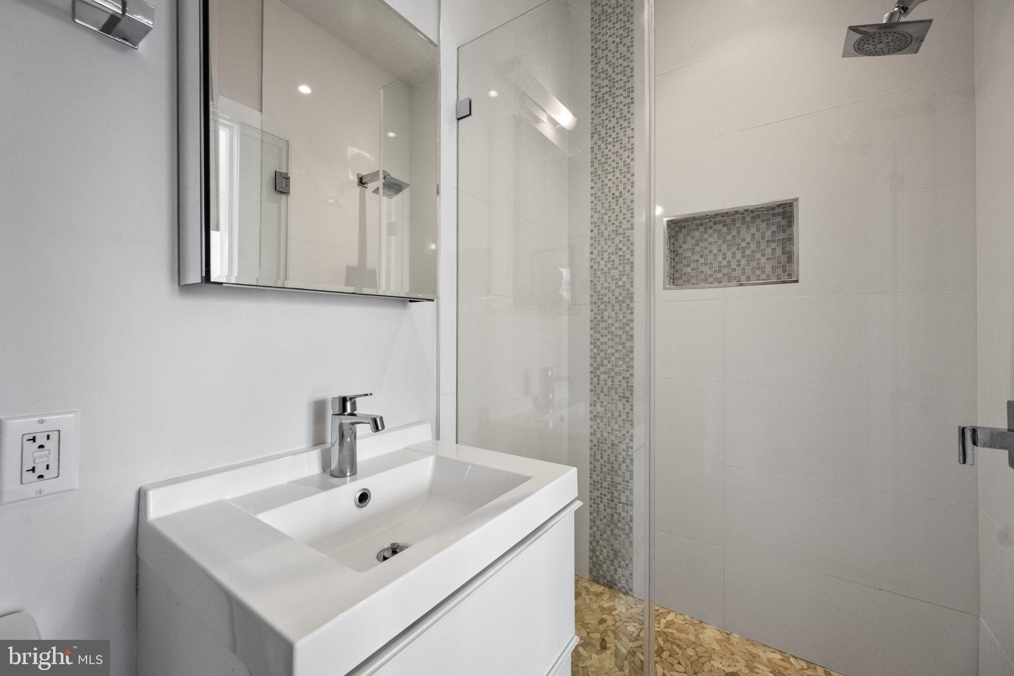 501 Rhode Island Avenue Northwest, Unit 2 Washington, DC 20001 - Photo 16 of 21 a bathroom with a sink a mirror and shower