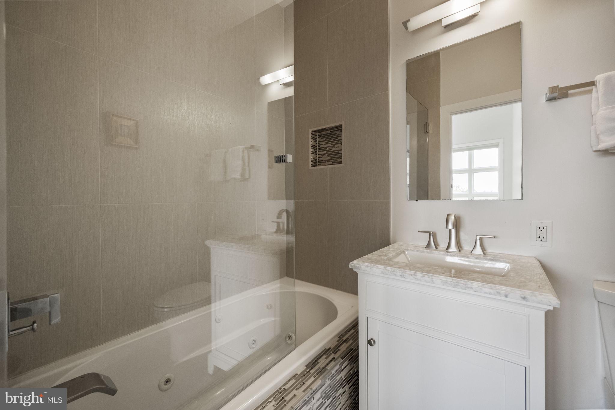 501 Rhode Island Avenue Northwest, Unit 2 Washington, DC 20001 - Photo 19 of 21 a bathroom with a sink a toilet and shower