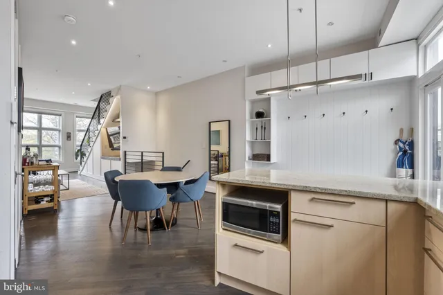 a kitchen with stainless steel appliances granite countertop a sink a stove and a refrigerator