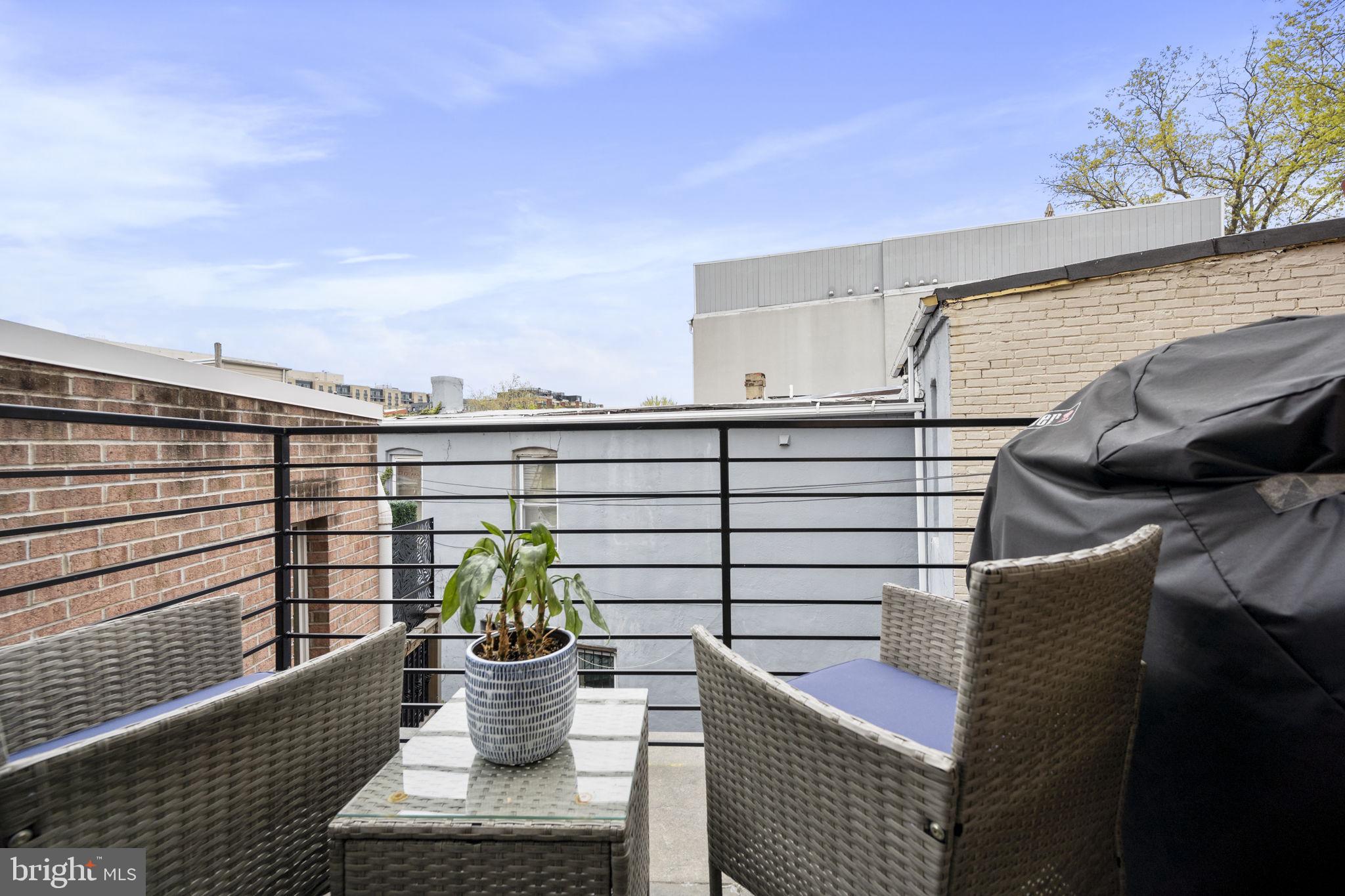 501 Rhode Island Avenue Northwest, Unit 2 Washington, DC 20001 - Photo 6 of 21 a view of a balcony with chair and potted plants