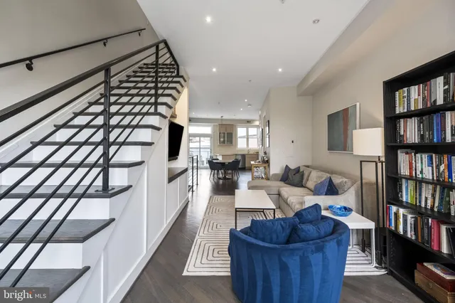 a living room with furniture and a book shelf