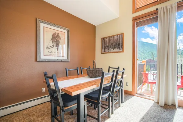 a view of a dining room with furniture and a window
