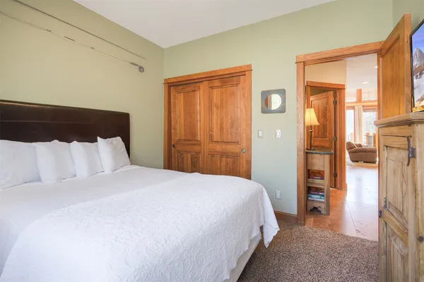 a bedroom with a bed and a mirror