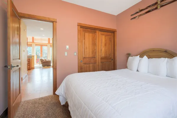 a bedroom with a bed and a mirror