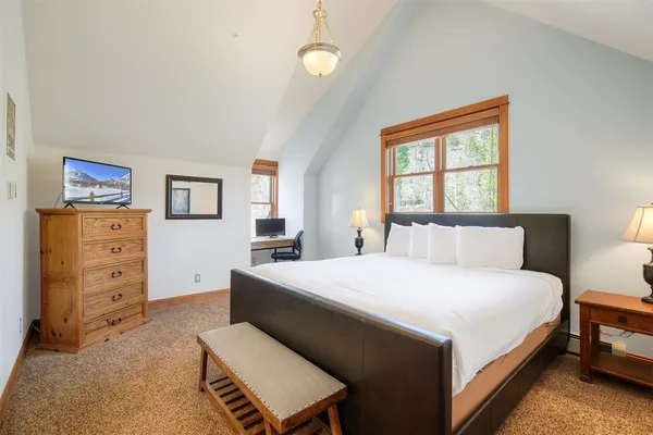 a bedroom with a bed and dresser