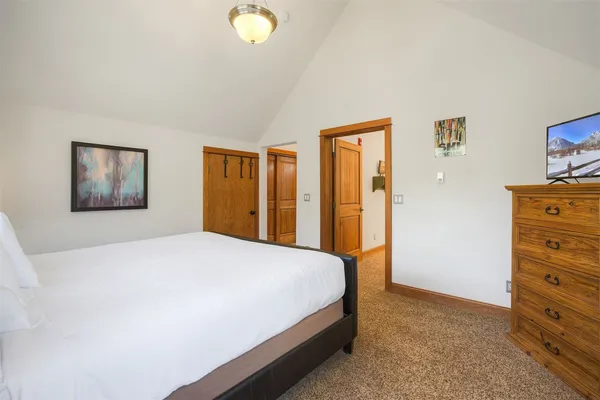 a bedroom with a bed and a dresser