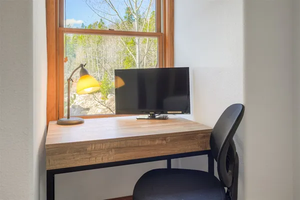 a view of a window with chair and table
