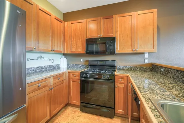 a kitchen with a stove a sink and a microwave