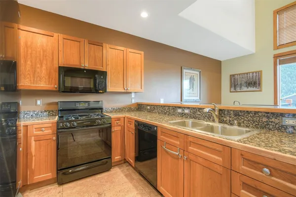 a kitchen with a sink stove and microwave