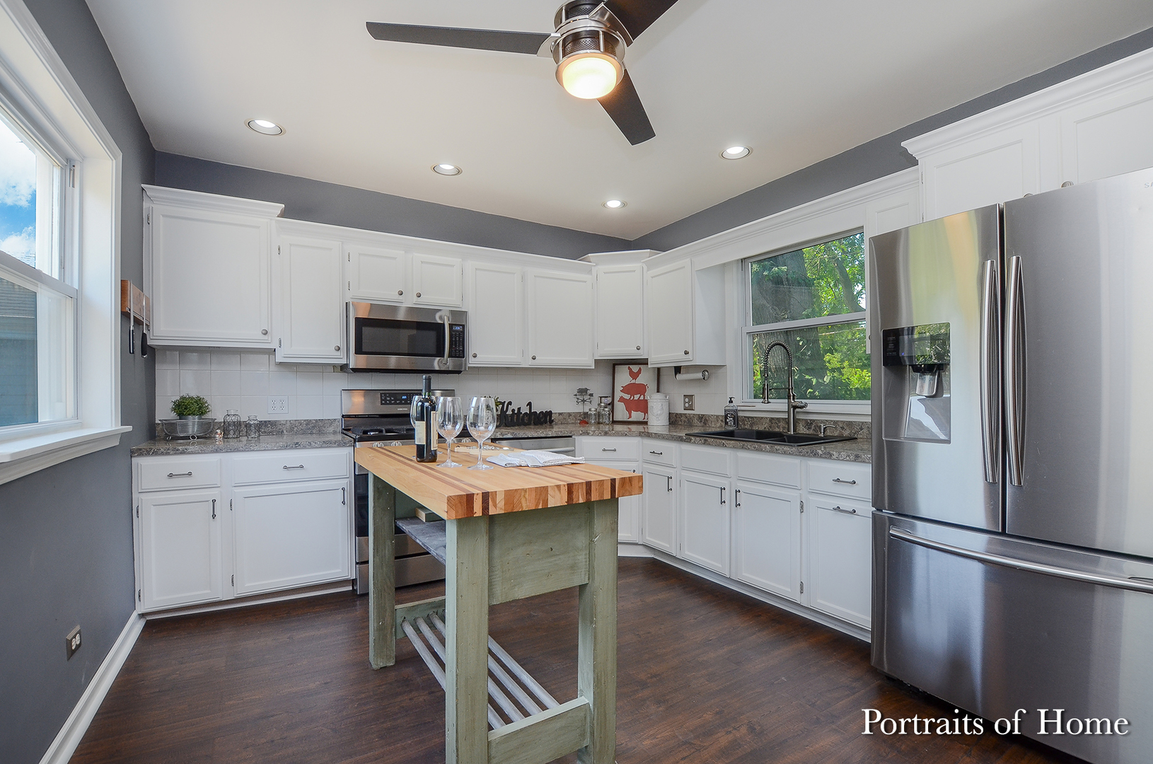 408 Crescent Street Wheaton, IL 60187 - Photo 11 of 36 a kitchen with granite countertop stainless steel appliances a sink a stove a refrigerator cabinets and a window