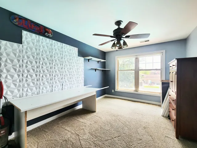 a view of a house with a yard and furniture