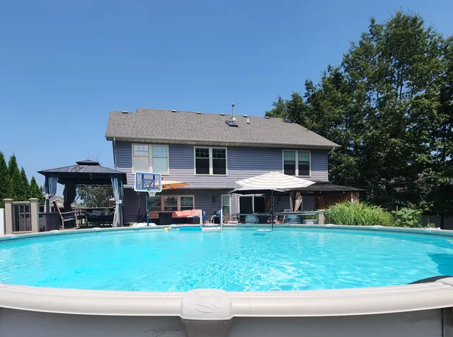 a view of a house with sitting area and garden