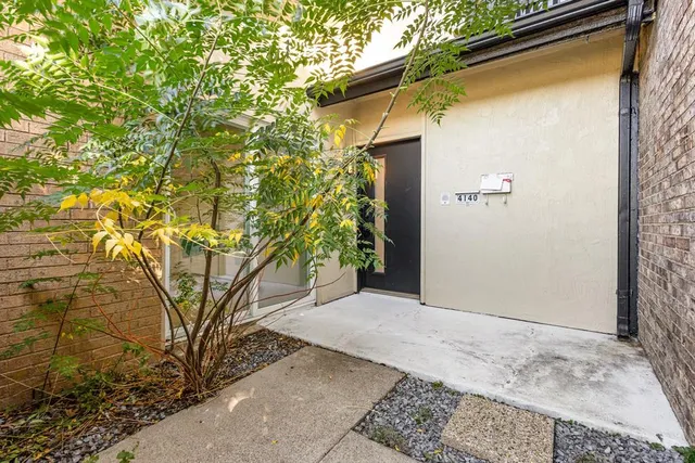 a view of a house with a tree