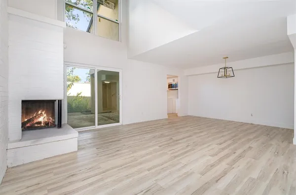 a view of an empty room and wooden floor