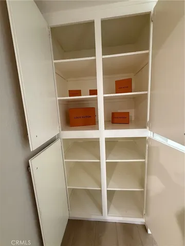 a view of walk in closet with empty racks