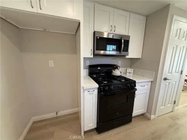 a kitchen with a stove and a microwave