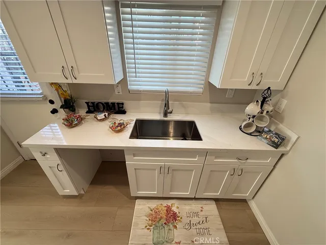 a kitchen with a sink and a stove top oven