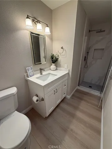 a spacious bathroom with a toilet sink and mirror