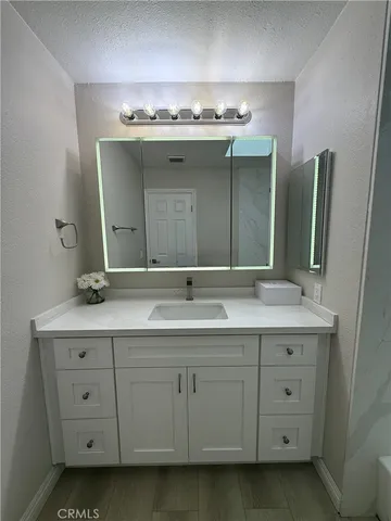 a bathroom with a double vanity sink and mirror