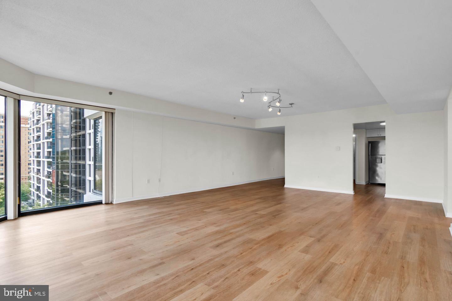 1530 Key Boulevard, Unit 715 Arlington, VA 22209 - Photo 15 of 41 a view of an empty room with wooden floor and a window