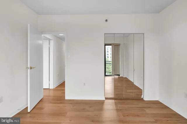 a view of hallway with wooden floor