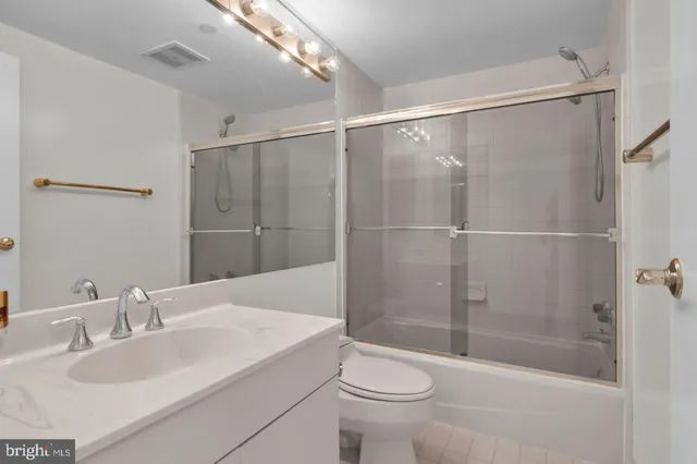 a bathroom with a sink mirror toilet and bathtub