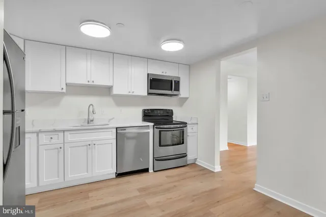 a kitchen with a stove and a sink