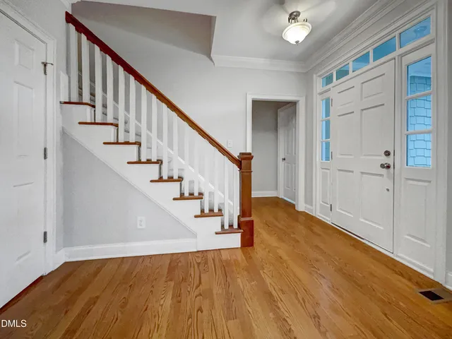 a view of entryway and hall with wooden floor