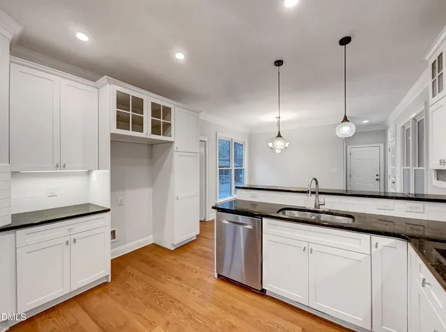 a kitchen with a sink window and cabinets