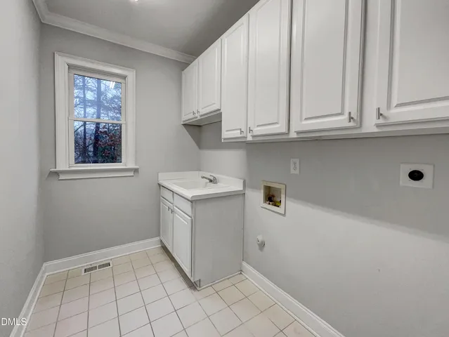 a utility room with cabinets