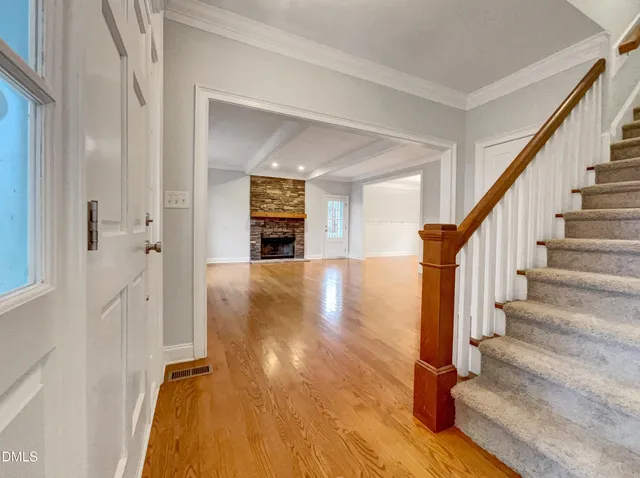 a view of an entryway with wooden floor and staircase