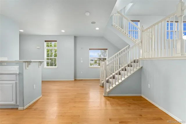 a view of entryway and hall with wooden floor