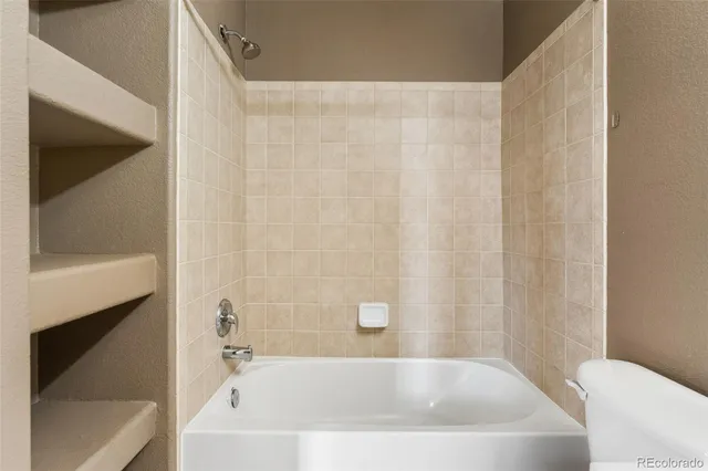 a bathroom with a white bath tub and a shower curtain
