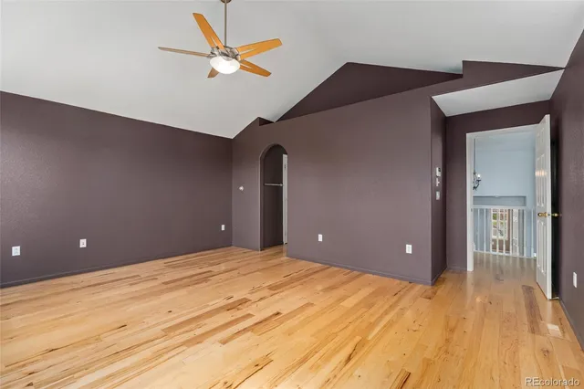 a view of a room that has a window and wooden floor