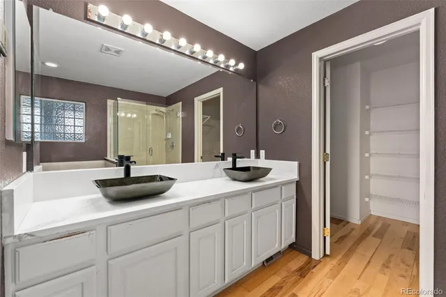 a bathroom with a sink double vanity and a mirror